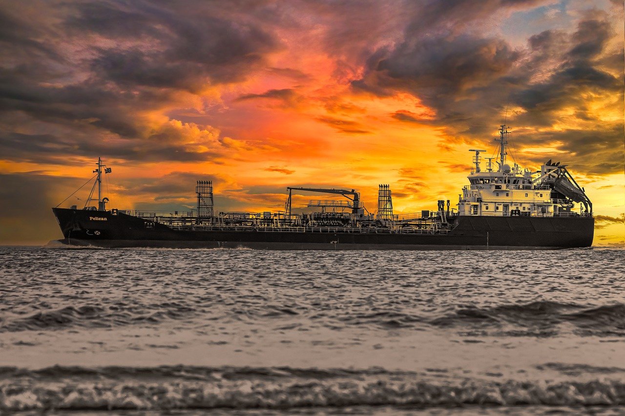 cargo ship, sunset, sea-7683972.jpg